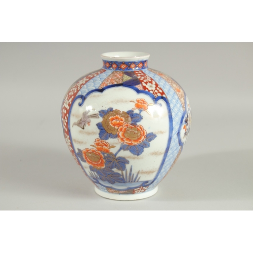 82 - A FINE JAPANESE IMARI PORCELAIN BULBOUS VASE, beautifully painted with panels of birds and native fl... 