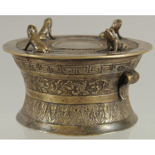 89 - AN ANNAMESE BRONZE RAIN DRUM WITH RELIEF CAST FROGS, 16cm diameter.