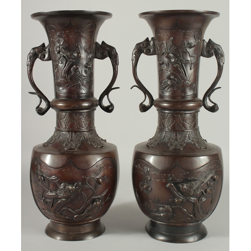 93 - A LARGE PAIR OF JAPANESE BRONZE TWIN HANDLE VASES, with relief decoration depicting birds on branche... 