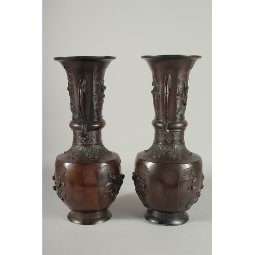 93 - A LARGE PAIR OF JAPANESE BRONZE TWIN HANDLE VASES, with relief decoration depicting birds on branche... 