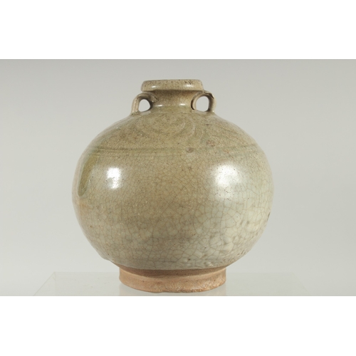 94 - A CELADON GLAZED POTTERY TWIN HANDLE BOTTLE / VASE, with carved decoration to the shoulder, 16cm hig... 