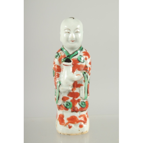 95 - A CHINESE COPPER RED AND GREEN PORCELAIN FIGURE, 11.5cm high.