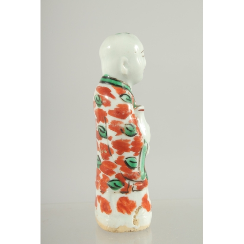 95 - A CHINESE COPPER RED AND GREEN PORCELAIN FIGURE, 11.5cm high.