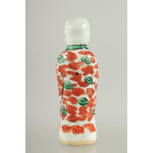 95 - A CHINESE COPPER RED AND GREEN PORCELAIN FIGURE, 11.5cm high.