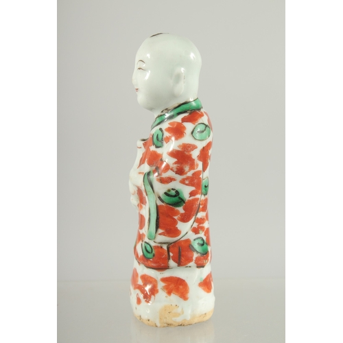 95 - A CHINESE COPPER RED AND GREEN PORCELAIN FIGURE, 11.5cm high.