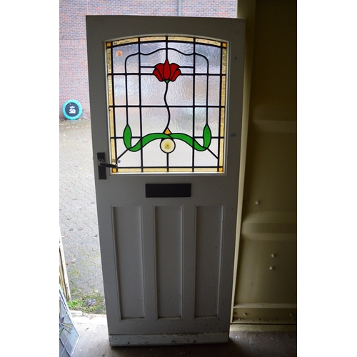 10 - An external door with stained glass leaded light panel.