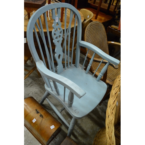 119 - A painted wheel back armchair.