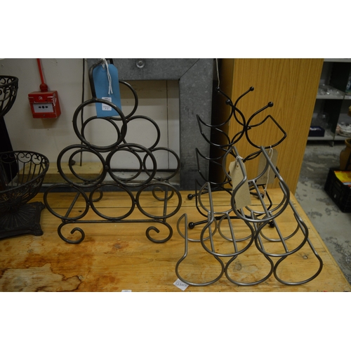 13 - Three wrought iron wine bottle stands.