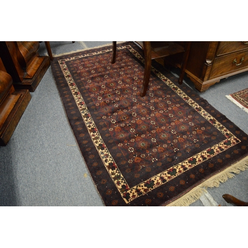 252 - A Persian rug with stylised floral decoration 200cm x 110cm.