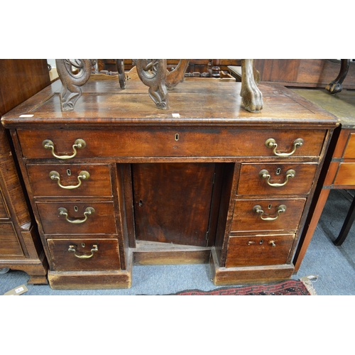 258 - A 19th century mahogany kneehole desk (faults).