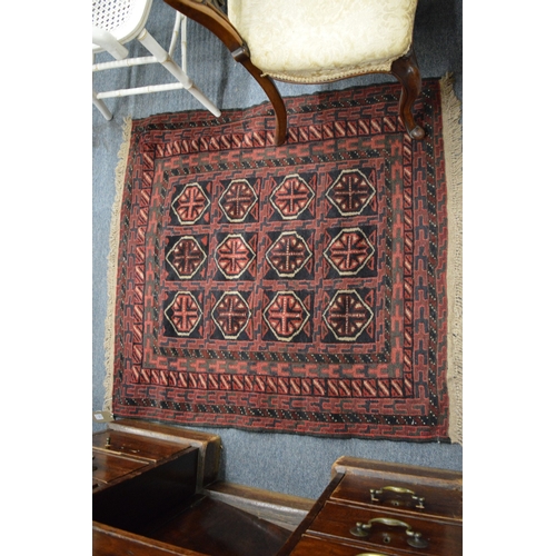 259 - A small Persian rug with stylised geometric decoration 110cm x 106cm.