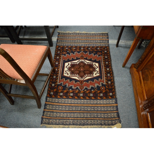 266 - A good small Persian rug with central geometric motif and woven decoration to each end 140cm x 80cm.