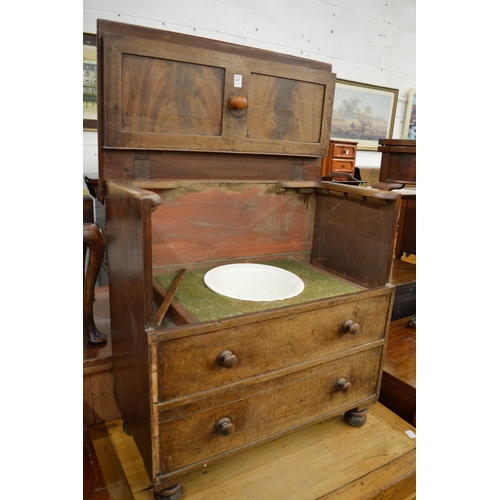 267 - A 19th century mahogany commode with rising top and porcelain liner.