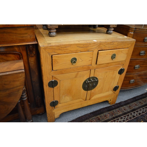 268 - A Chinese light elm chest with two drawers and two cupboard doors.