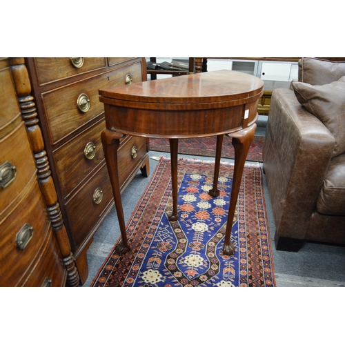 269 - A mahogany demi-lune fold over card table.