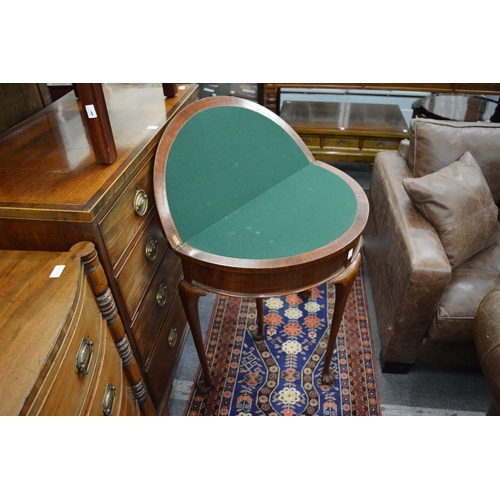 269 - A mahogany demi-lune fold over card table.