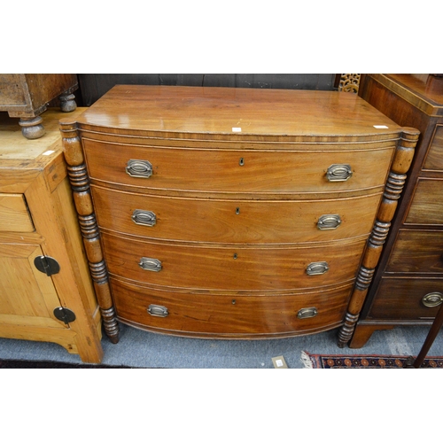 270 - An early 19th century mahogany bow front four drawer chest with turned column supports.