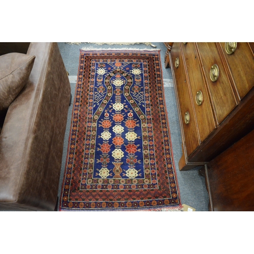 274 - A good Persian prayer, blue ground with stylised floral decoration 145cm x 78cm.