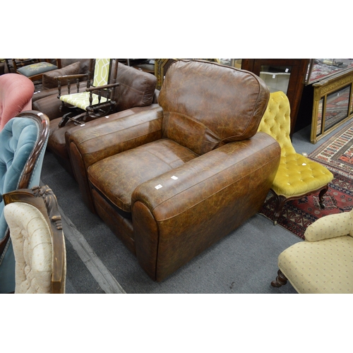 283 - A brown leather upholstered armchair.