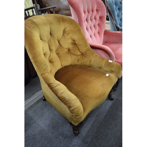 290 - A Victorian rosewood and button upholstered armchair.
