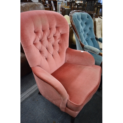 291 - A pink draylon button upholstered armchair.