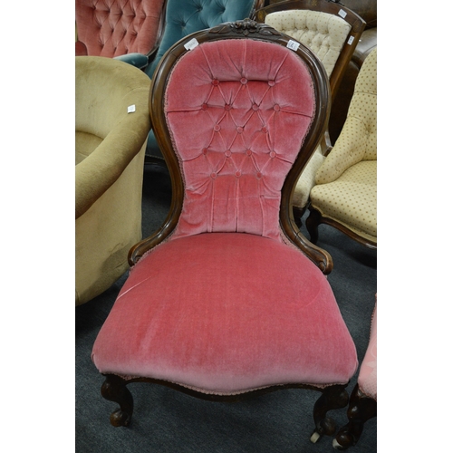 296 - A Victorian walnut framed and button upholstered nursing chair.