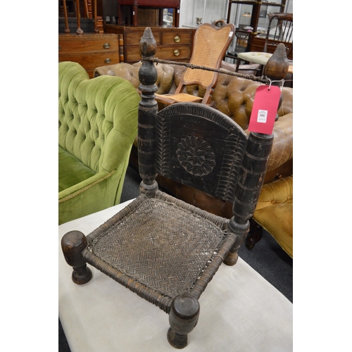 300 - An African low chair with woven seat.