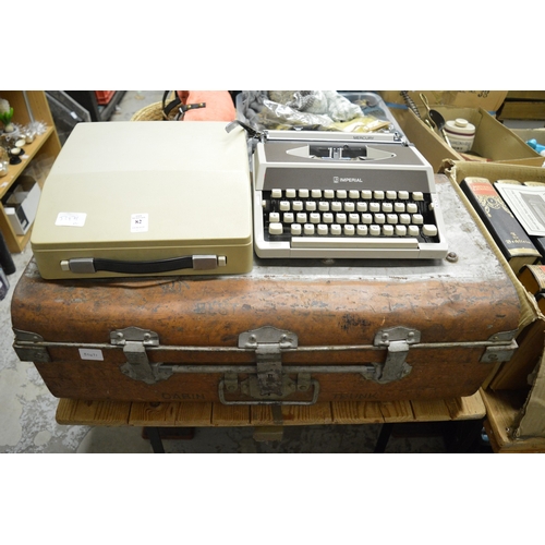 82 - Portable typewriter and a tin trunk.