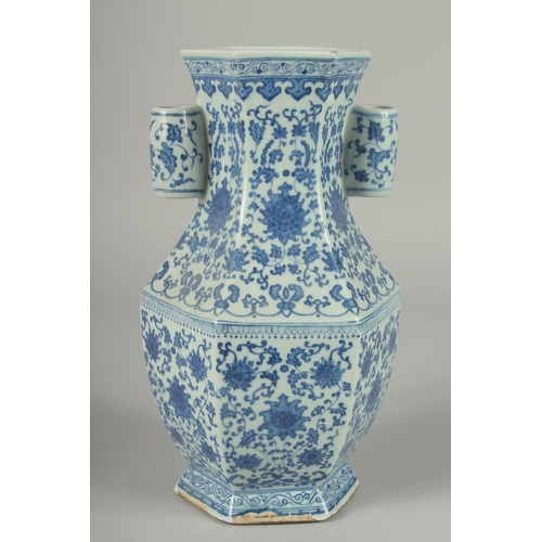 100 - A CHINESE BLUE AND WHITE PORCELAIN HEXAGONAL VASE, with twin cylindrical tubed handles and lotus dec... 