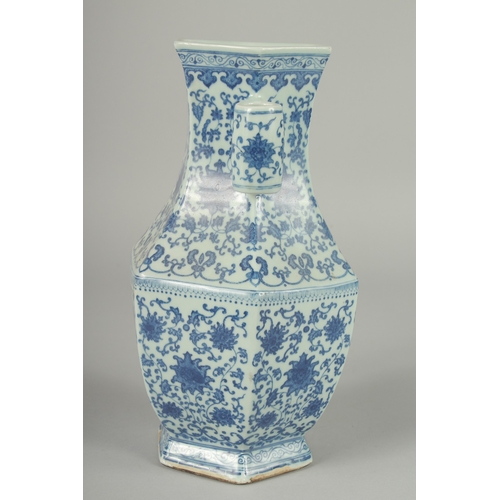 100 - A CHINESE BLUE AND WHITE PORCELAIN HEXAGONAL VASE, with twin cylindrical tubed handles and lotus dec... 