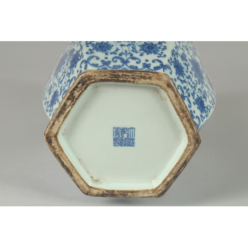 100 - A CHINESE BLUE AND WHITE PORCELAIN HEXAGONAL VASE, with twin cylindrical tubed handles and lotus dec... 