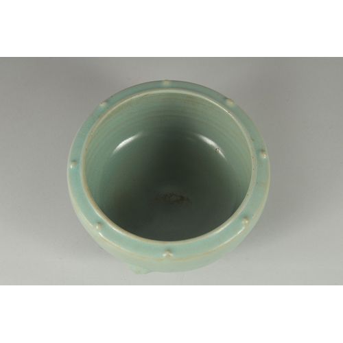 105 - A CHINESE CELADON GLAZE PORCELAIN BOWL, the sides with moulded handles and rim with raised bosses, 1... 