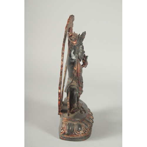 124 - A TIBETAN BRONZE DEITY, with detachable halo.