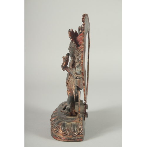 124 - A TIBETAN BRONZE DEITY, with detachable halo.