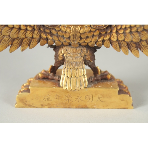 125 - A FINE TIBETAN GILT BRONZE DEITY, with wings outstretched, inscribed to the base, 19cm wide.