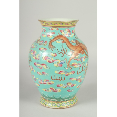 135 - A 19TH CENTURY CHINESE TURQUOISE GROUND FAMILLE ROSE PORCELAIN DRAGON VASE, the body enamel painted ... 