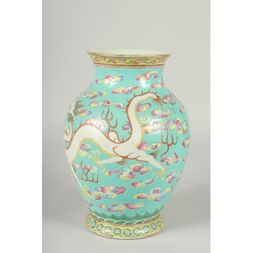 135 - A 19TH CENTURY CHINESE TURQUOISE GROUND FAMILLE ROSE PORCELAIN DRAGON VASE, the body enamel painted ... 