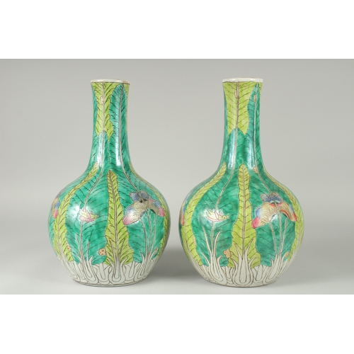 137 - A PAIR OF CHINESE FAMILLE VERTE PORCELAIN BOTTLE VASES, painted with butterflies and leaves, 35cm hi... 