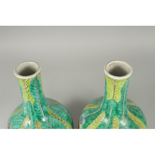 137 - A PAIR OF CHINESE FAMILLE VERTE PORCELAIN BOTTLE VASES, painted with butterflies and leaves, 35cm hi... 