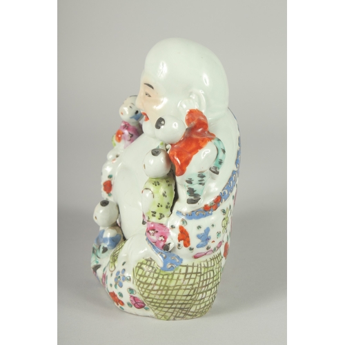 139 - A CHINESE FAMILLE ROSE PORCELAIN BUDDHA, with five children upon him, 19.5cm high.