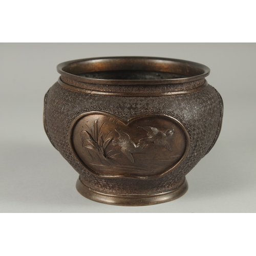 140 - A JAPANESE BRONZE JARDINIERE, with relief panels of birds, 19cm diameter.