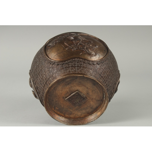 140 - A JAPANESE BRONZE JARDINIERE, with relief panels of birds, 19cm diameter.