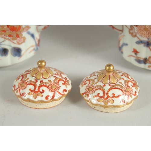 145 - A FINE PAIR OF JAPANESE IMARI PORCELAIN TEAPOTS, painted in the typical Imari palette with blue, red... 