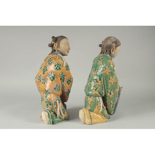 149 - A LARGE PAIR OF 19TH CENTURY CHINESE SANCAI GLAZED POTTERY FIGURES, 33cm high.