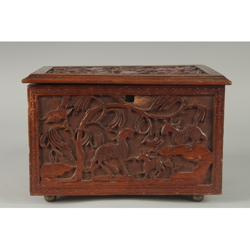 155 - A GOOD CHINESE CARVED WOOD TEA CHEST, carved with various animals including fish, goats, and birds, ... 