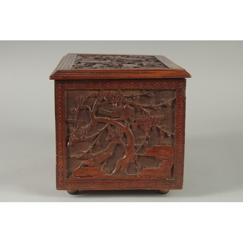 155 - A GOOD CHINESE CARVED WOOD TEA CHEST, carved with various animals including fish, goats, and birds, ... 