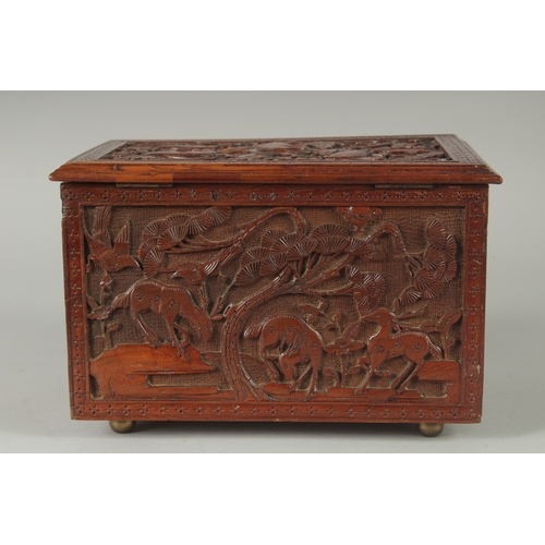 155 - A GOOD CHINESE CARVED WOOD TEA CHEST, carved with various animals including fish, goats, and birds, ... 