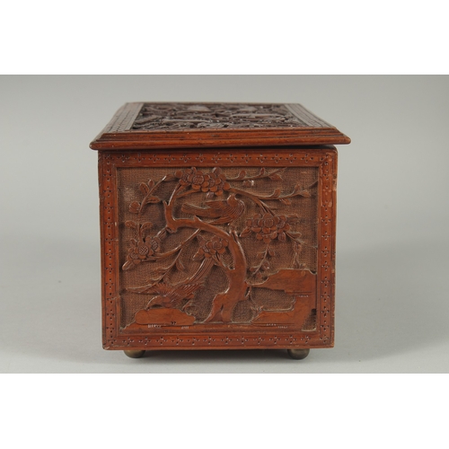 155 - A GOOD CHINESE CARVED WOOD TEA CHEST, carved with various animals including fish, goats, and birds, ... 