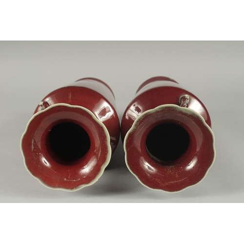 156 - A PAIR OF CHINESE SANG DE BOEUF TWIN HANDLE VASES, (one with minor rim repair), 34cm high (slightly ... 