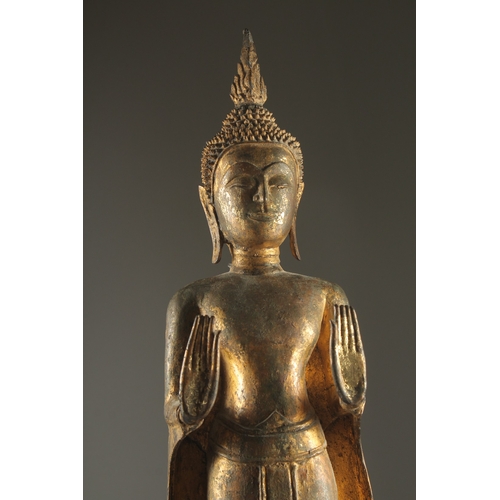 159 - A FINE AND LARGE 19TH CENTURY OR EARLIER THAI GILDED BRONZE BUDDHA, stood upon a graduating circular... 